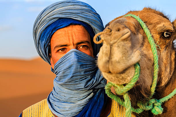 young tuareg with camel on western sahara desert in africa